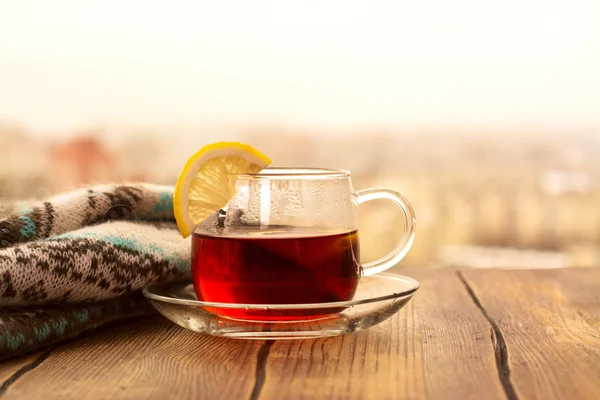 Черный чай с дольками лимона в чашку стекла — стоковое фото
