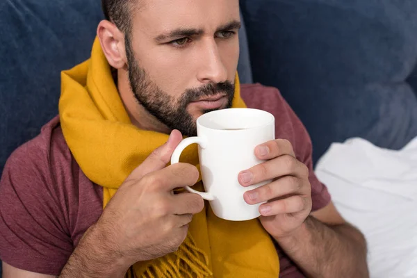 Sick Young Man Scarf Holding Cup Hot Tea Bed — стоковое фото