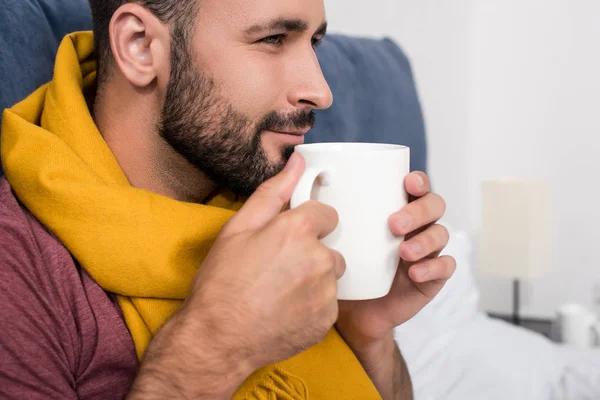 Close Portrait Smiling Sick Young Man Scarf Holding Cup Hot — стоковое фото